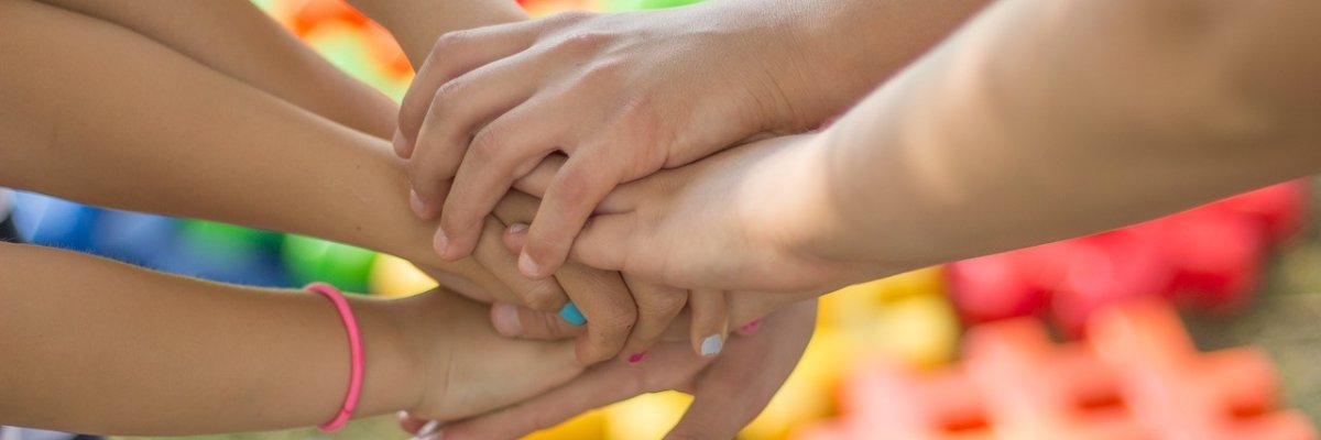 Hands Hands are held over each other in a circle.
