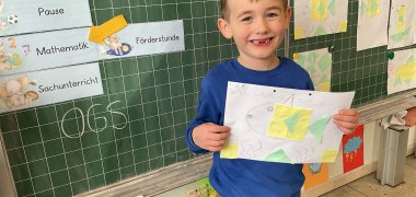 A boy shows his picture