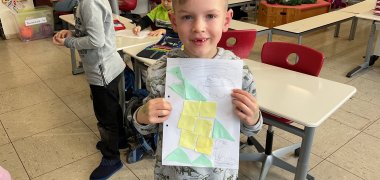 A boy shows his picture
