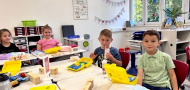 Children show off their organic bread boxes