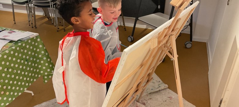 Kinderen schilderen op een doek